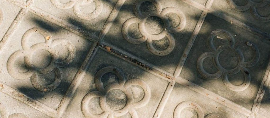 Custom stamped concrete tiles with a decorative flower motif