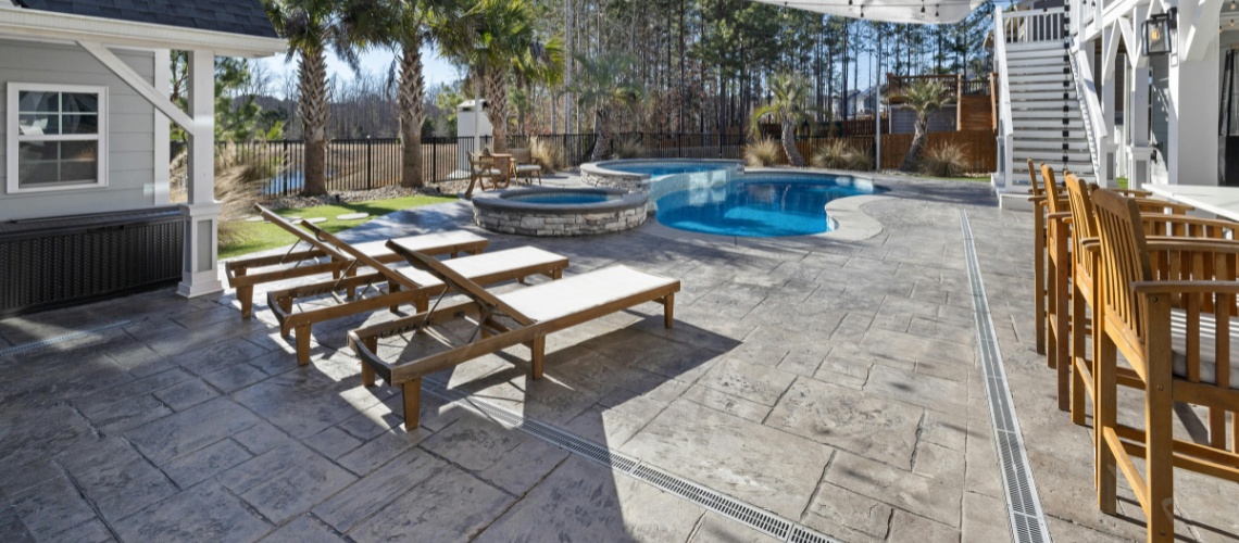 wide backyard patio with stamped concrete